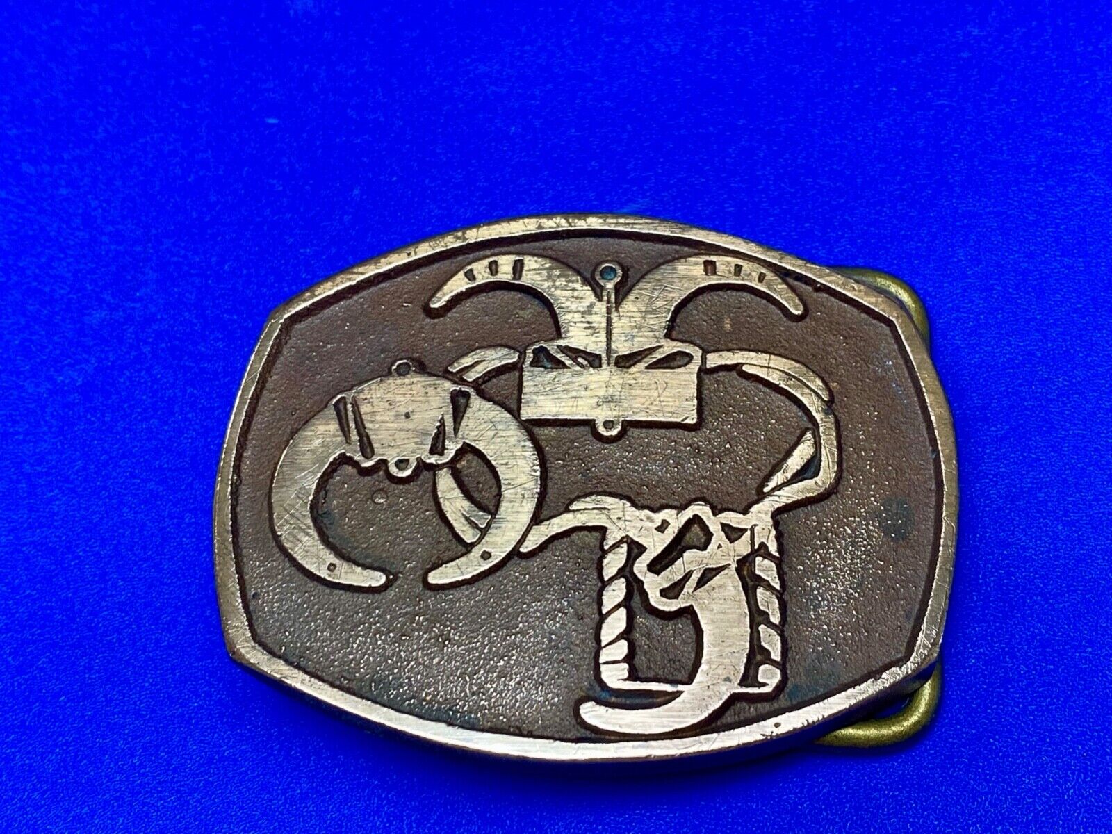unknown to me - cattle branding symbols? longhorn western? belt buckle