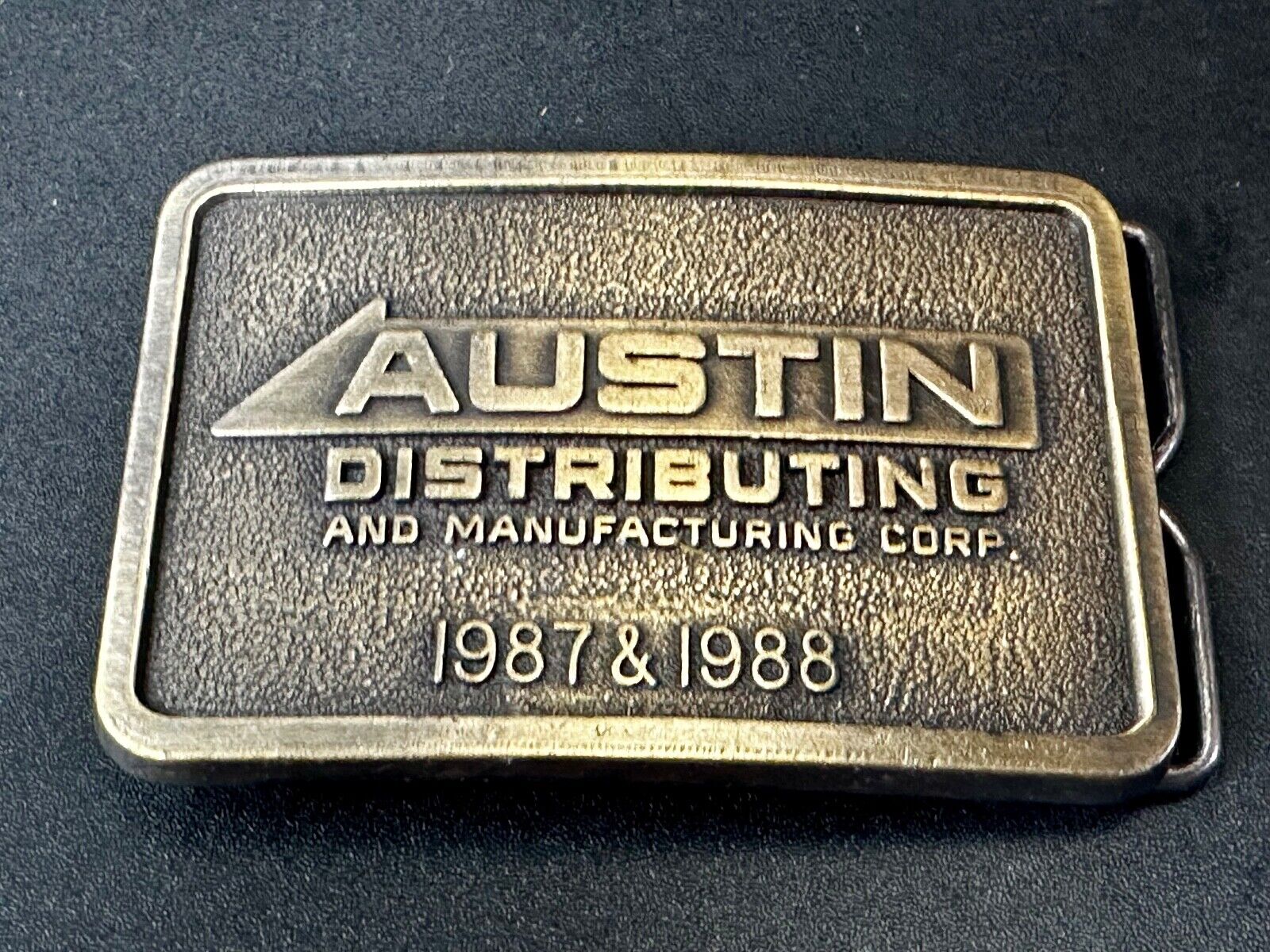 Austin Texas Distributing and Manufacturing 1987 Advertisement Promo Belt Buckle