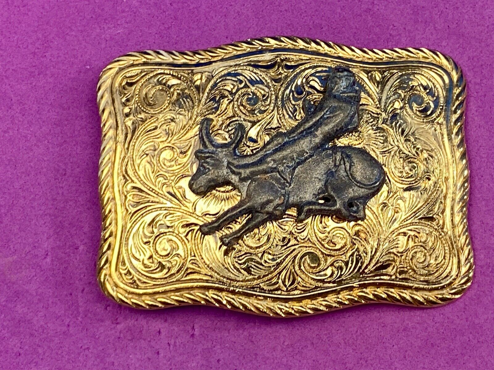 bull riding rodeo cowboy on beautiful gold color flower swirl belt buckle 
