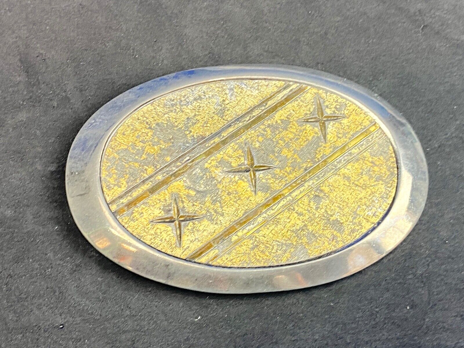 Unique XXX gold tone belt buckle tic tac toe pattern