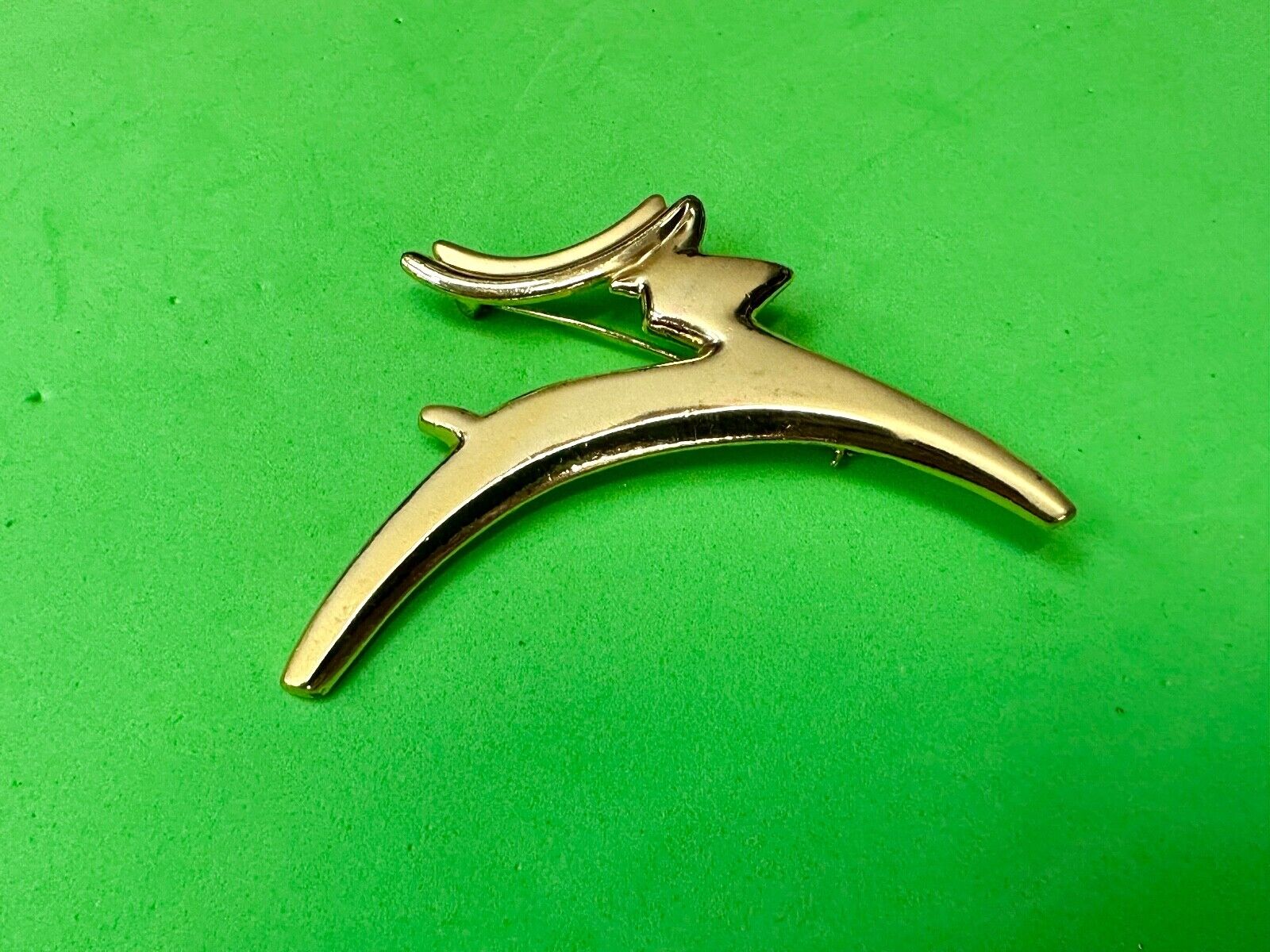 Abstract gold tone running deer - Vintage Christmas Holliday Brooch by AJC