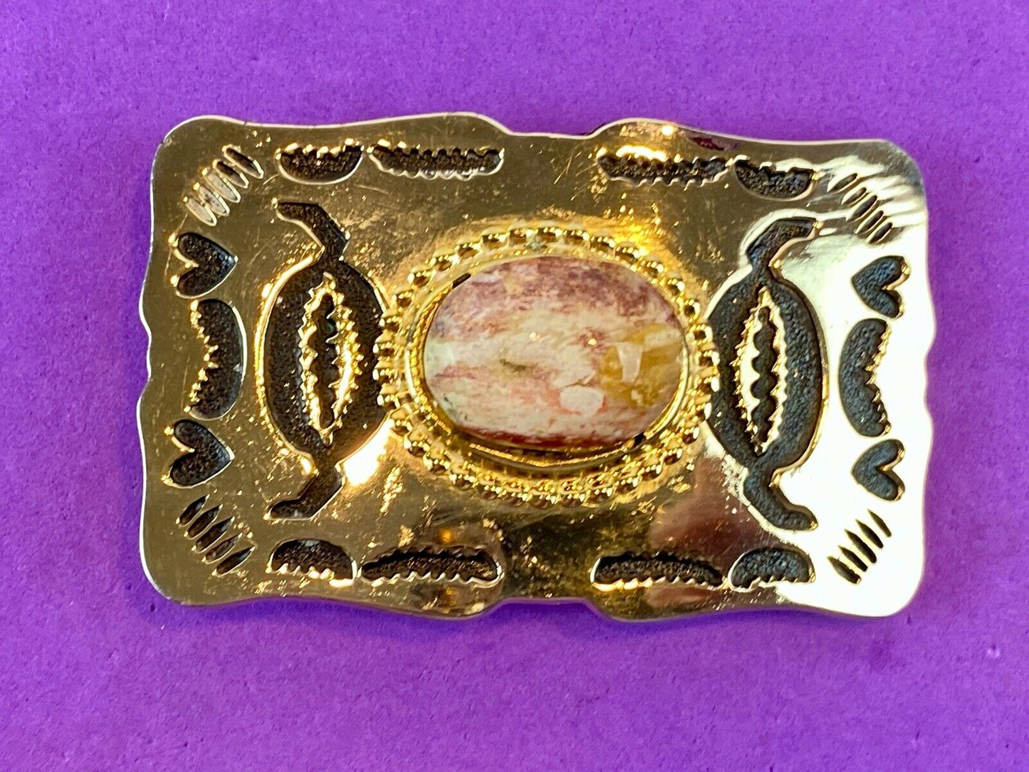 unknown multi layered colored stone as centerpiece in western belt buckle