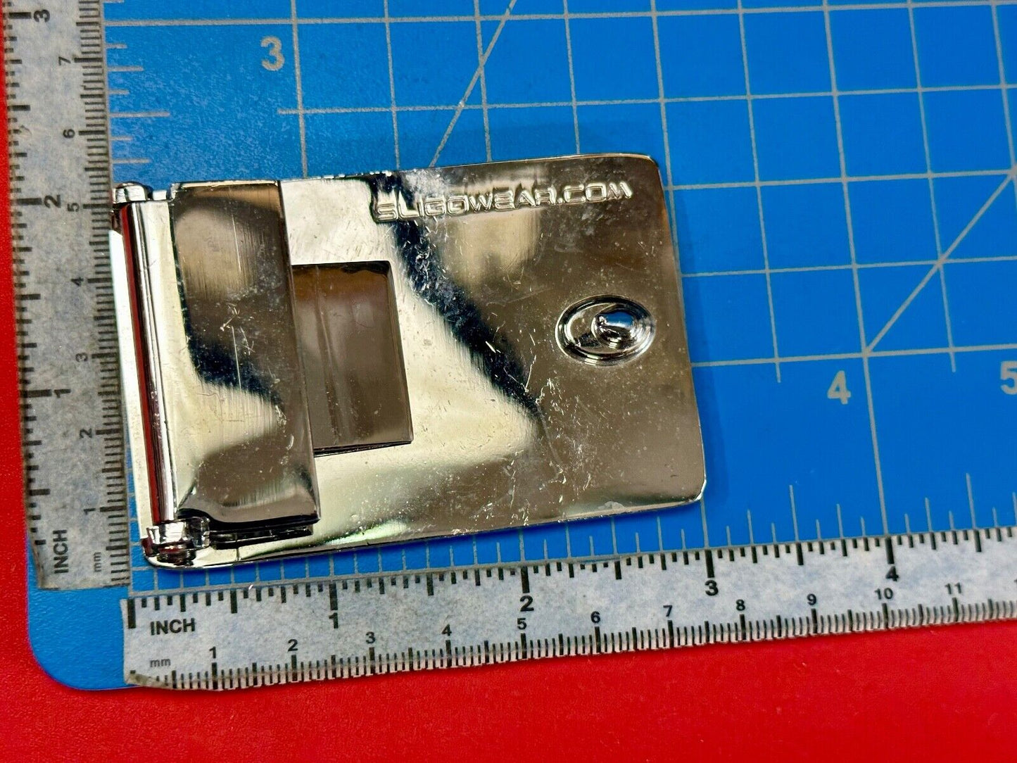 unknown to me!   Sligo Sugowear blue colored emblem or logo belt buckle