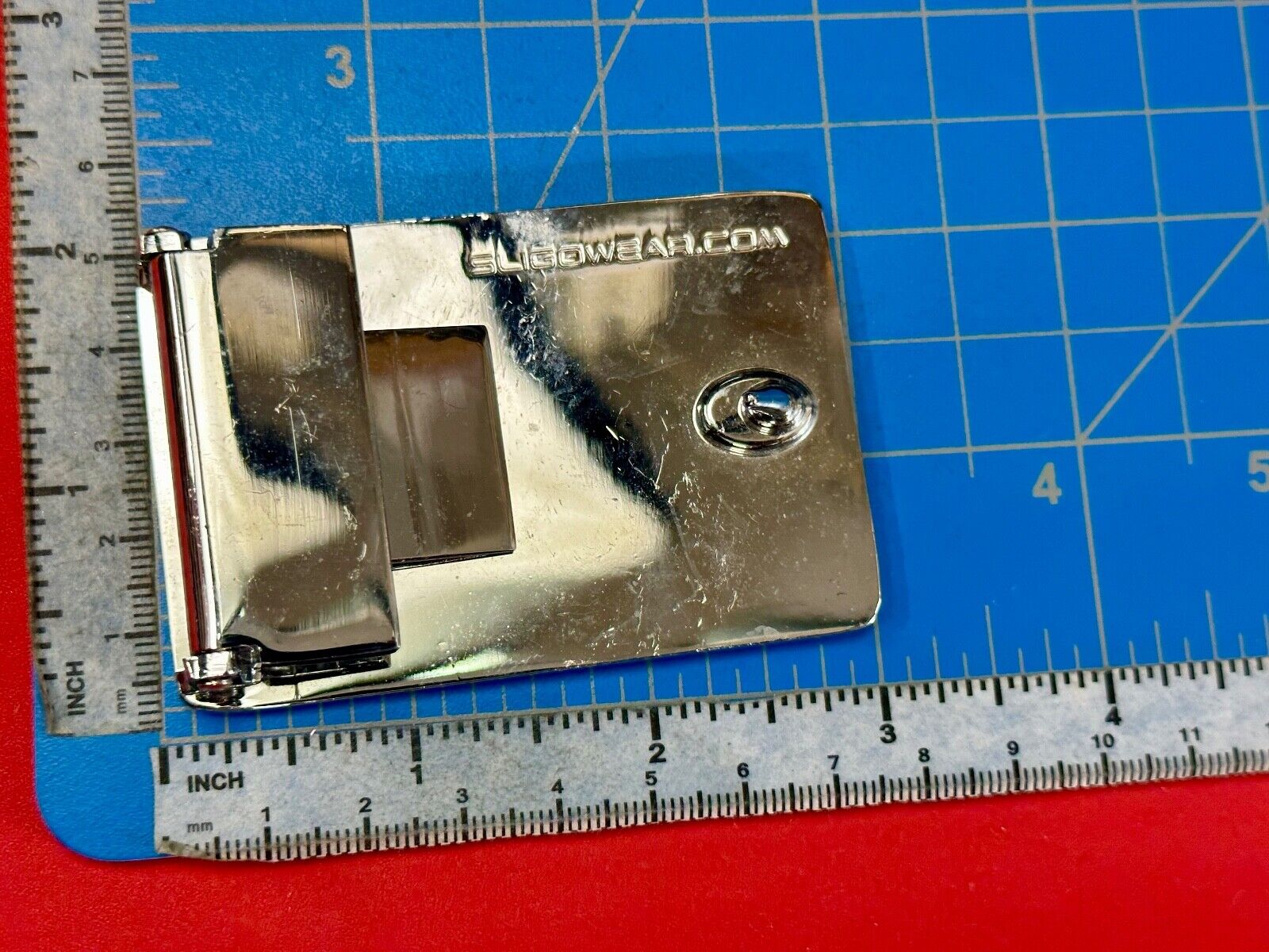 unknown to me!   Sligo Sugowear blue colored emblem or logo belt buckle