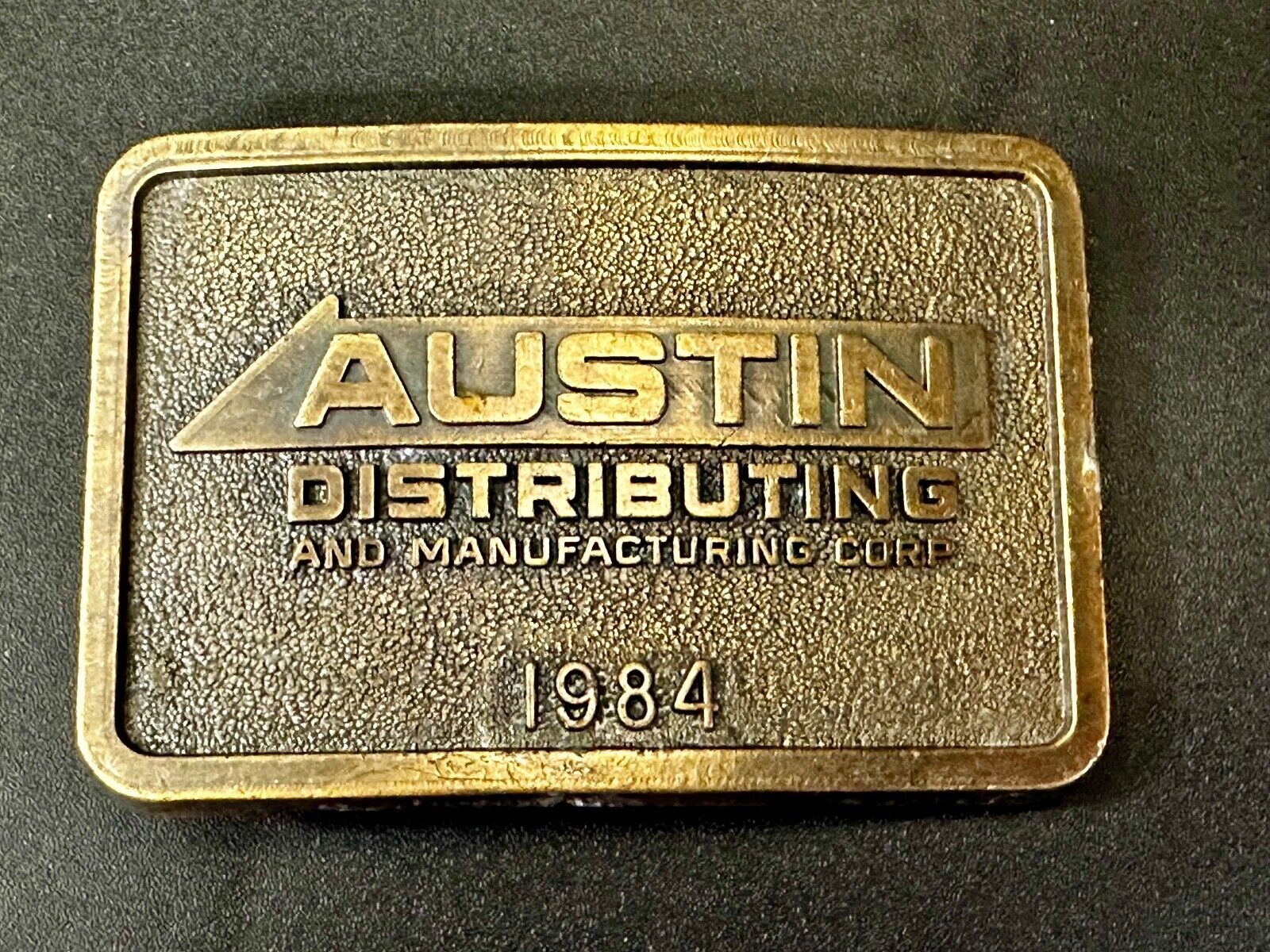 Austin Texas Distributing and Manufacturing 1984 Advertisement Promo Belt Buckle