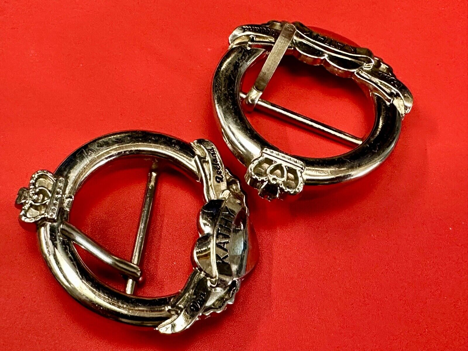 Two Kathy Van Zeeland signed silver tone round heart accented belt buckles