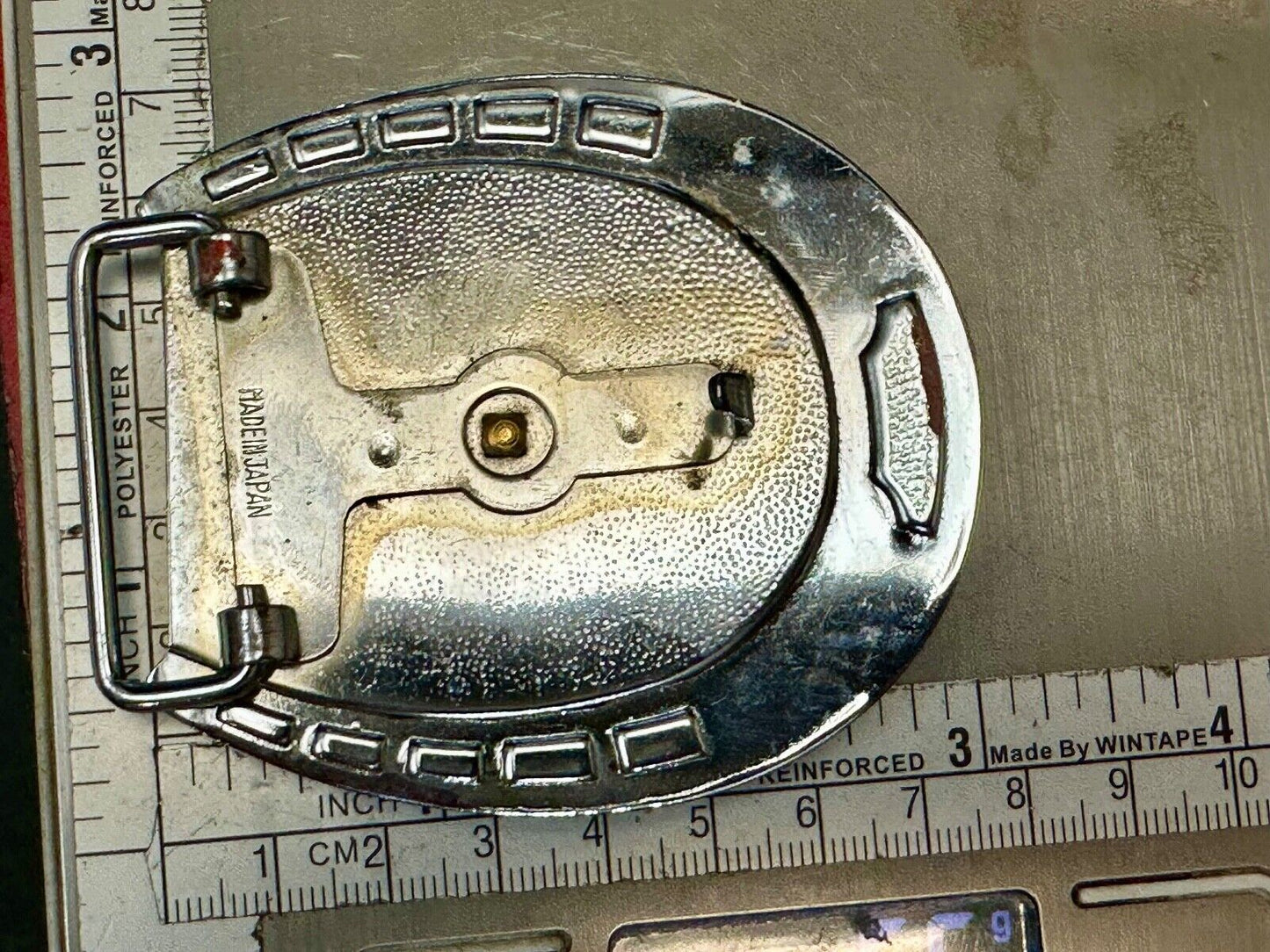 Artisan Resin covered Horseshoe shaped Belt Buckle with gold tone standing horse