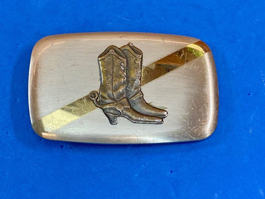 Vintage cowboy boots with spurs in center of mixed metal western belt buckle 