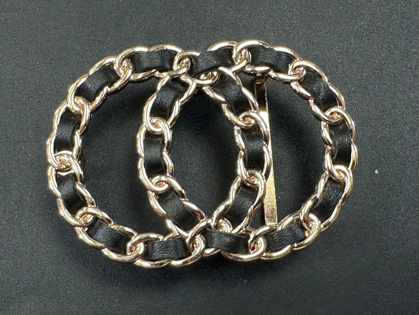 Two gold tone Overlapping Circle's with black ribbon through-out belt buckle