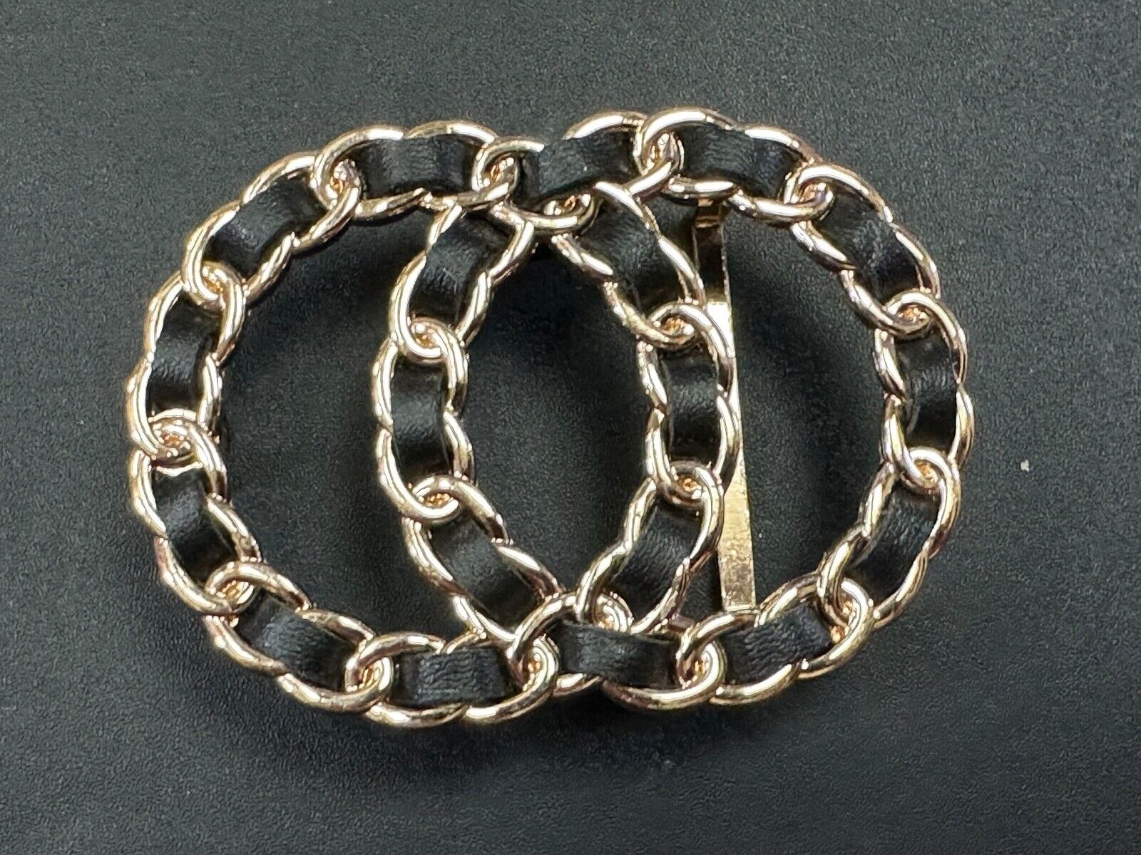 Two gold tone Overlapping Circle's with black ribbon through-out belt buckle