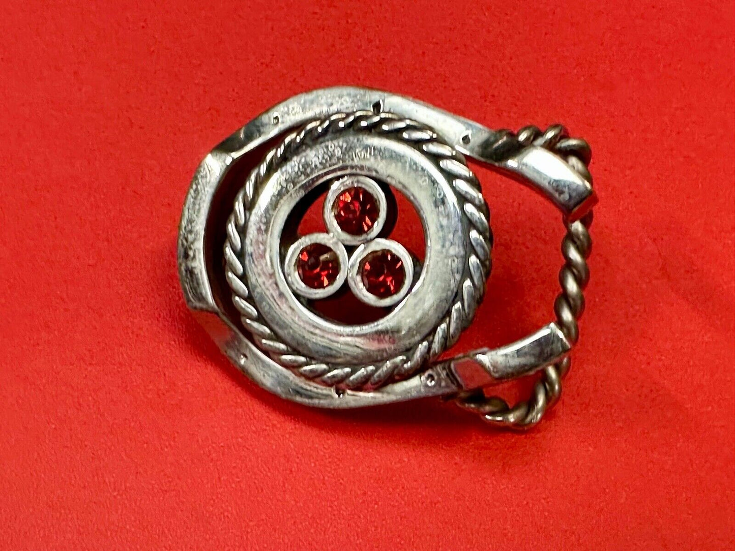 artisan circle pattern rope centerpiece red dots horseshoe shaped belt buckle