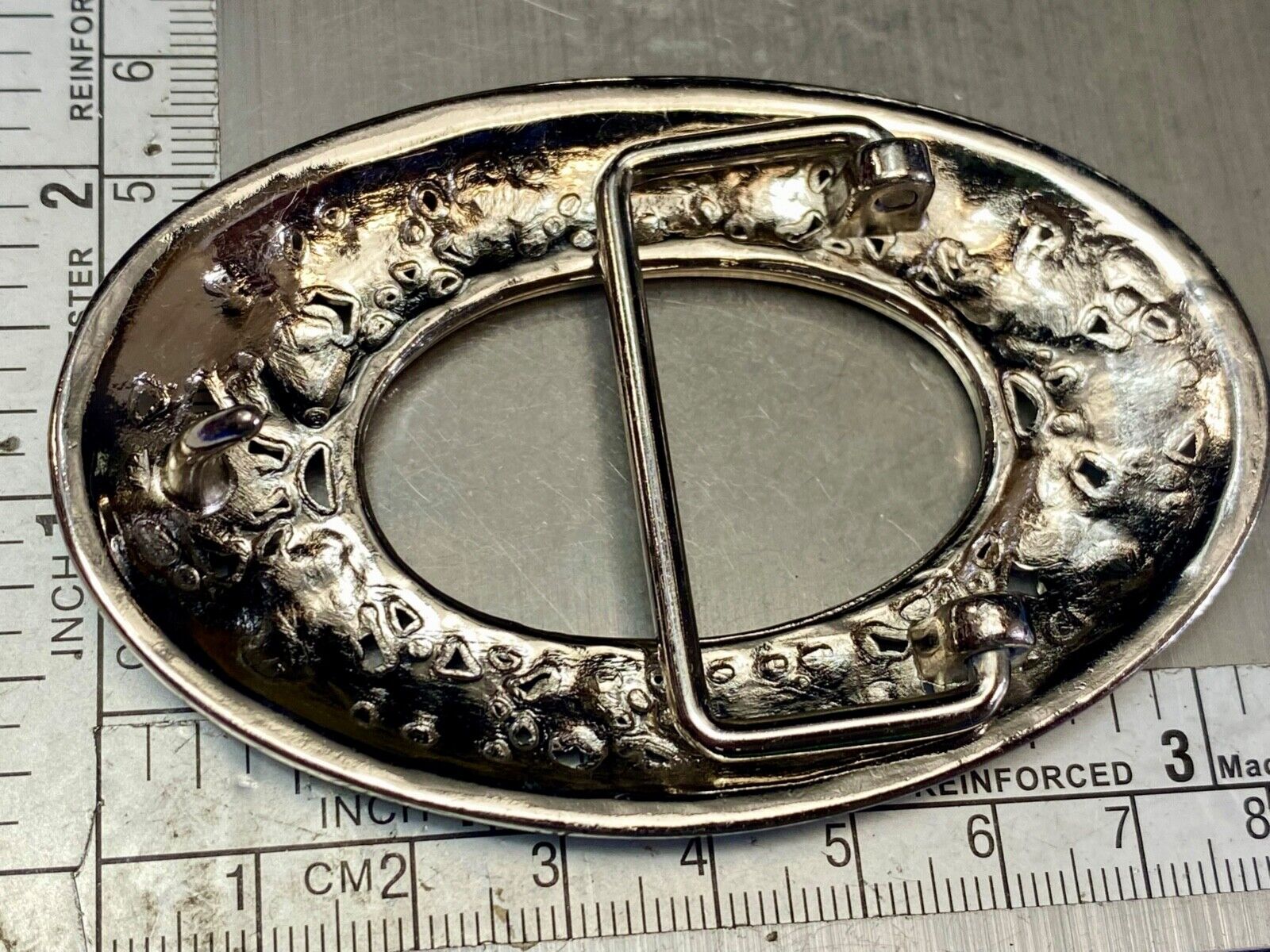 Unique blue rhinestone accented oval see though silver tone belt buckle
