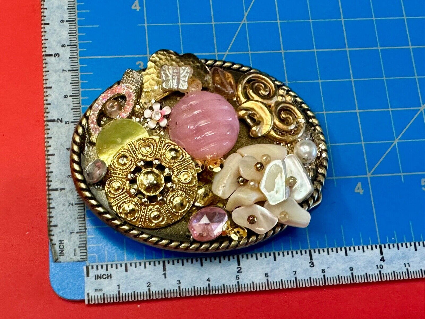 Artisan Abstract flowers made of mixed material on gold tone oval belt buckle