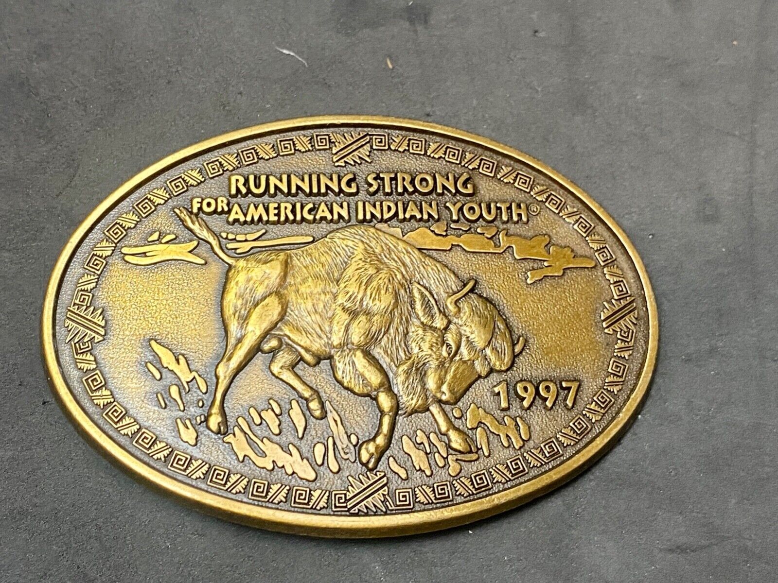 Vintage 1997 BUFFALO belt buckle RUNNING STRONG FOR AMERICAN INDIAN YOUTH