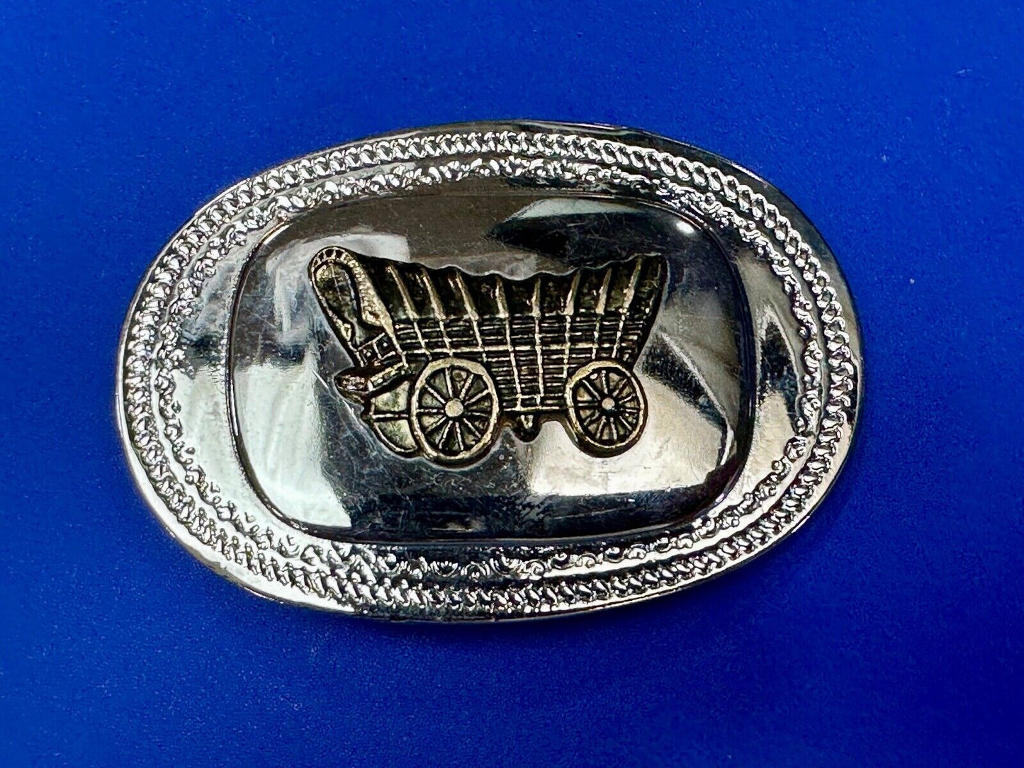 70s Covered Wagon two tone reflective oval ornate boarder belt buckle