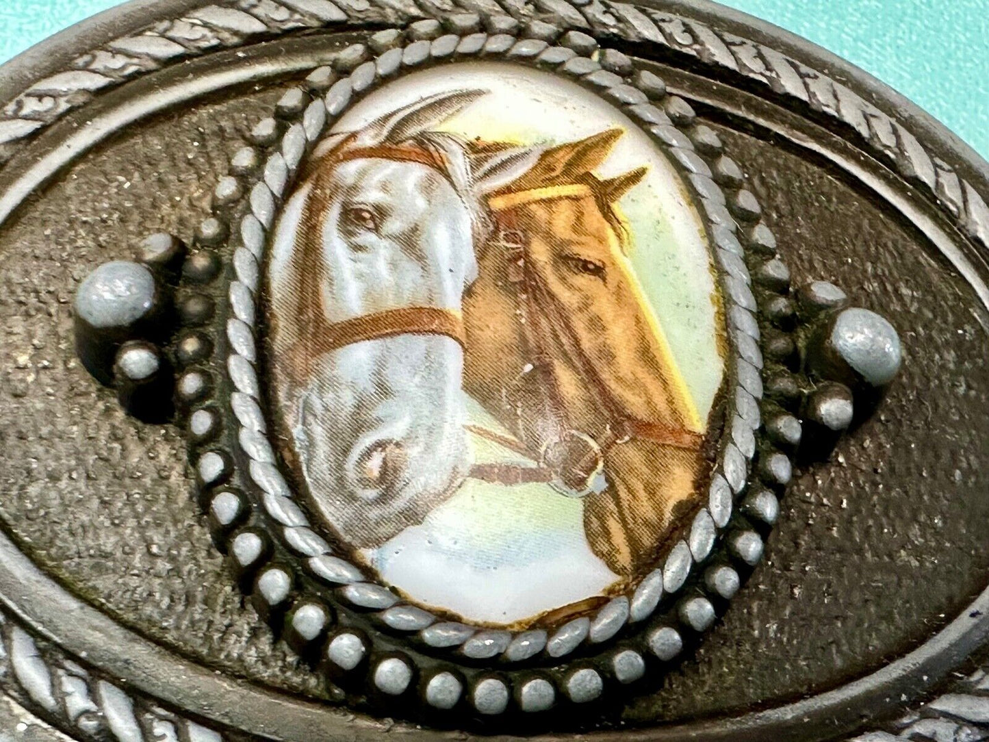 2 horses picture as centerpiece in western oval belt buckle with rope border