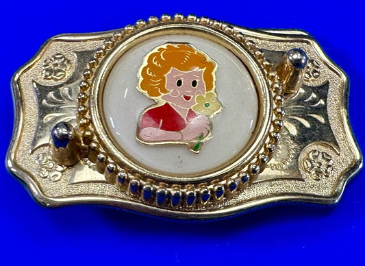 Adorable red headed girl with flower as centerpiece on western belt buckle