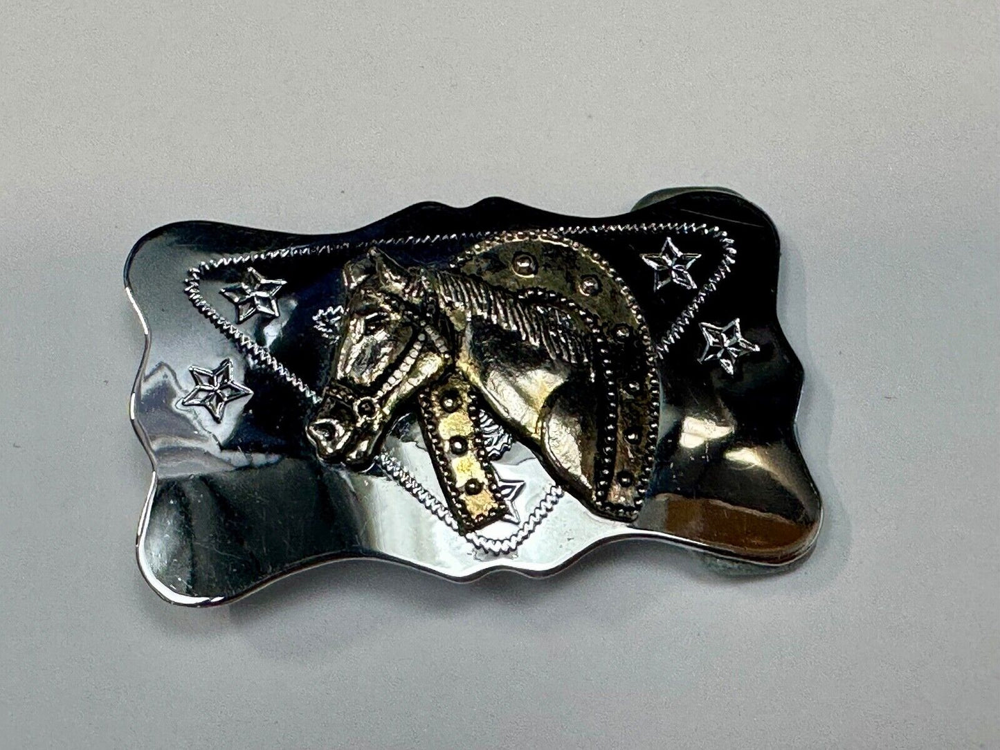 Vintage horse head through lucky horseshoe on reflective western belt buckle