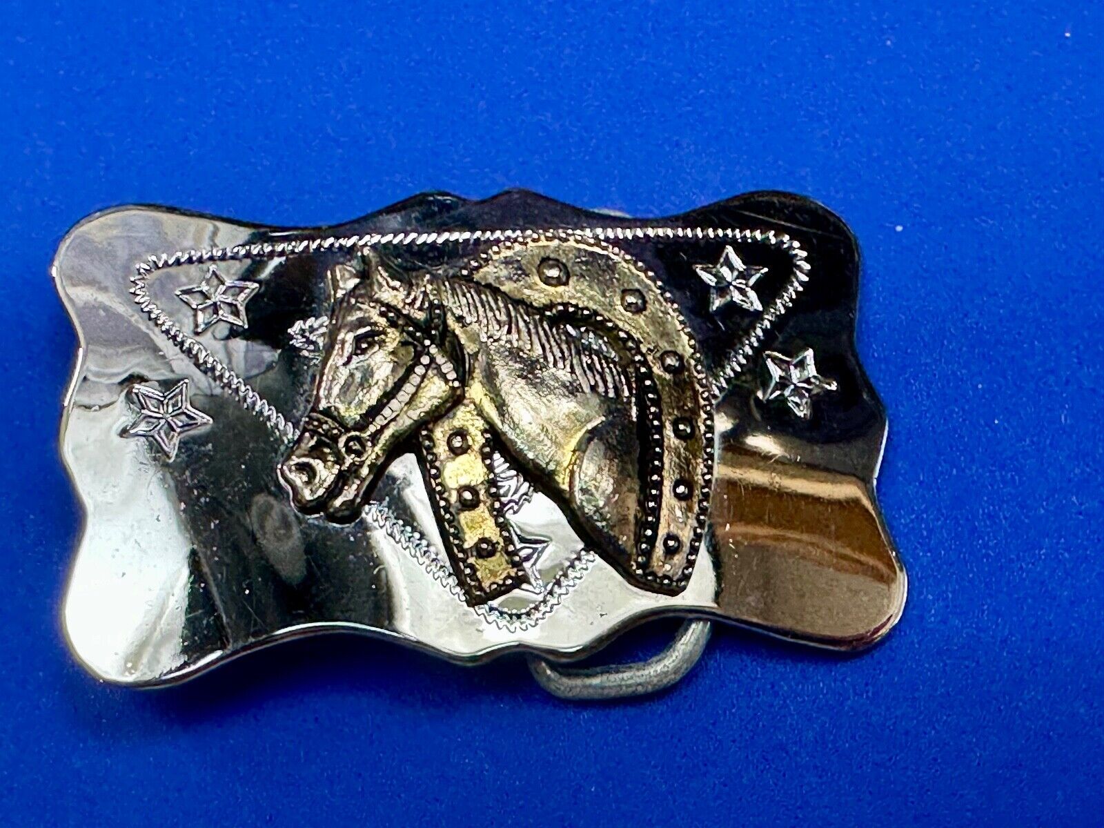 Vintage horse head through lucky horseshoe on reflective western belt buckle