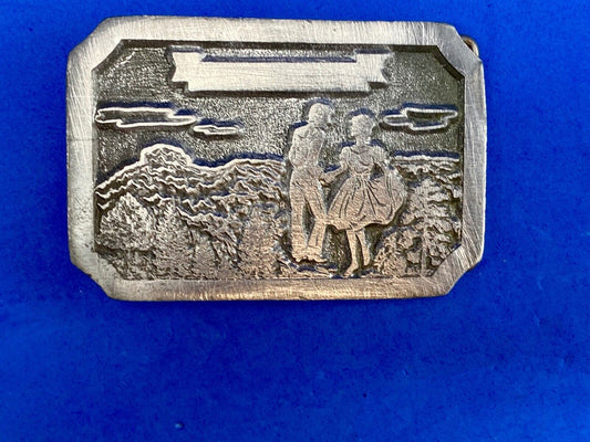 Vintage daleco belt buckle featuring a dancing couple 