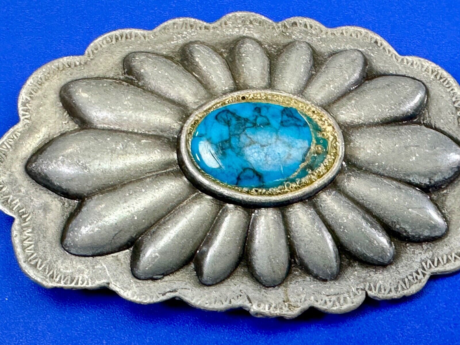 Turquoise stone centered on Vintage metal flower theme belt buckle