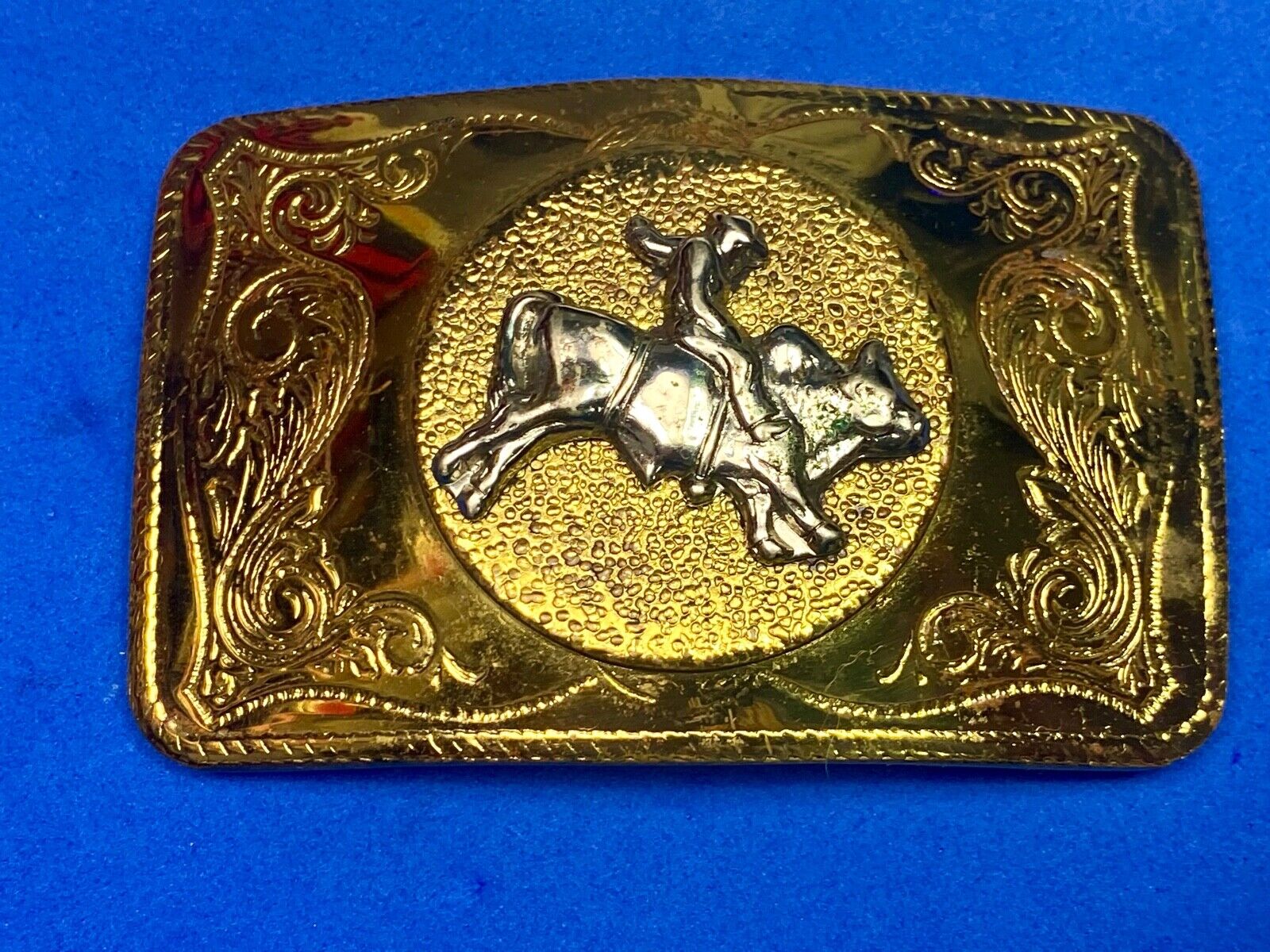 Beautiful ornate solid brass rodeo cowboy on rectangular western belt buckle 