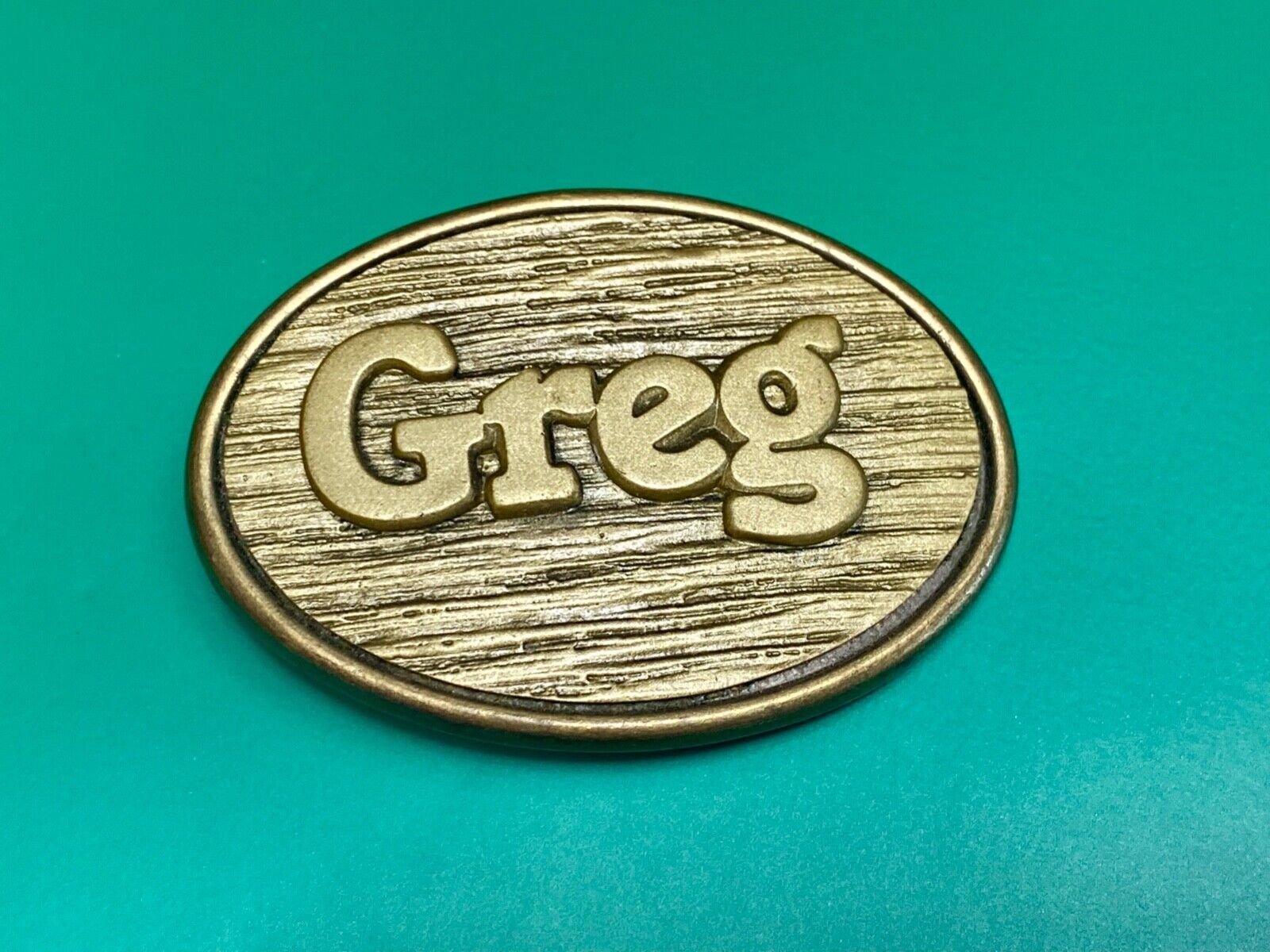 Vintage GREG name metal wood grain western Belt Buckle By Oden - Made In USA