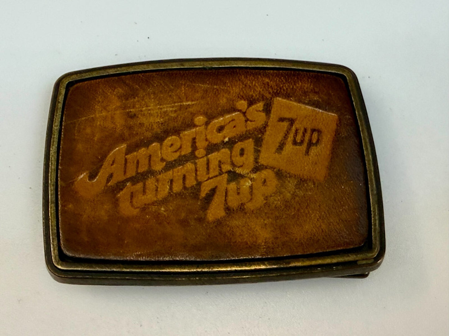 America's Turning 7up Embossed Leather on Metal Advertising Promo Belt Buckle