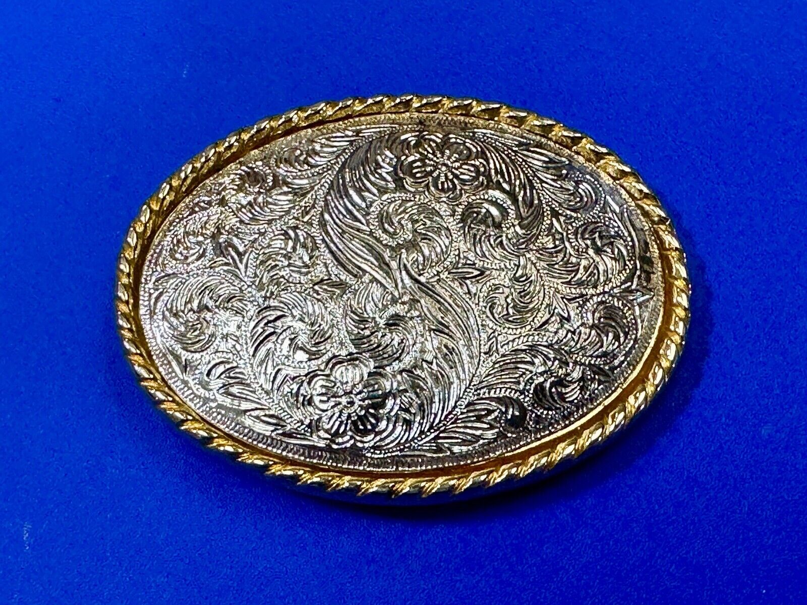 vintage Ivan Brand western flower swirl design two tone oval belt buckle