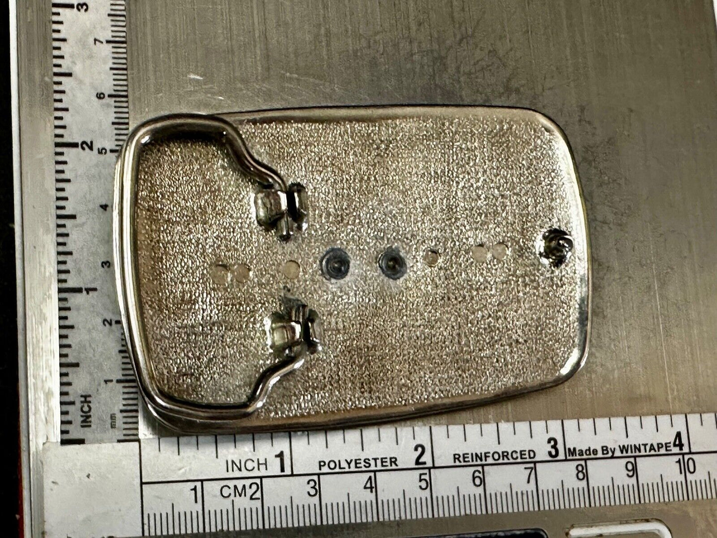 Vintage Cowboy on Saddle Bronc Western belt buckle with mesh pattern background