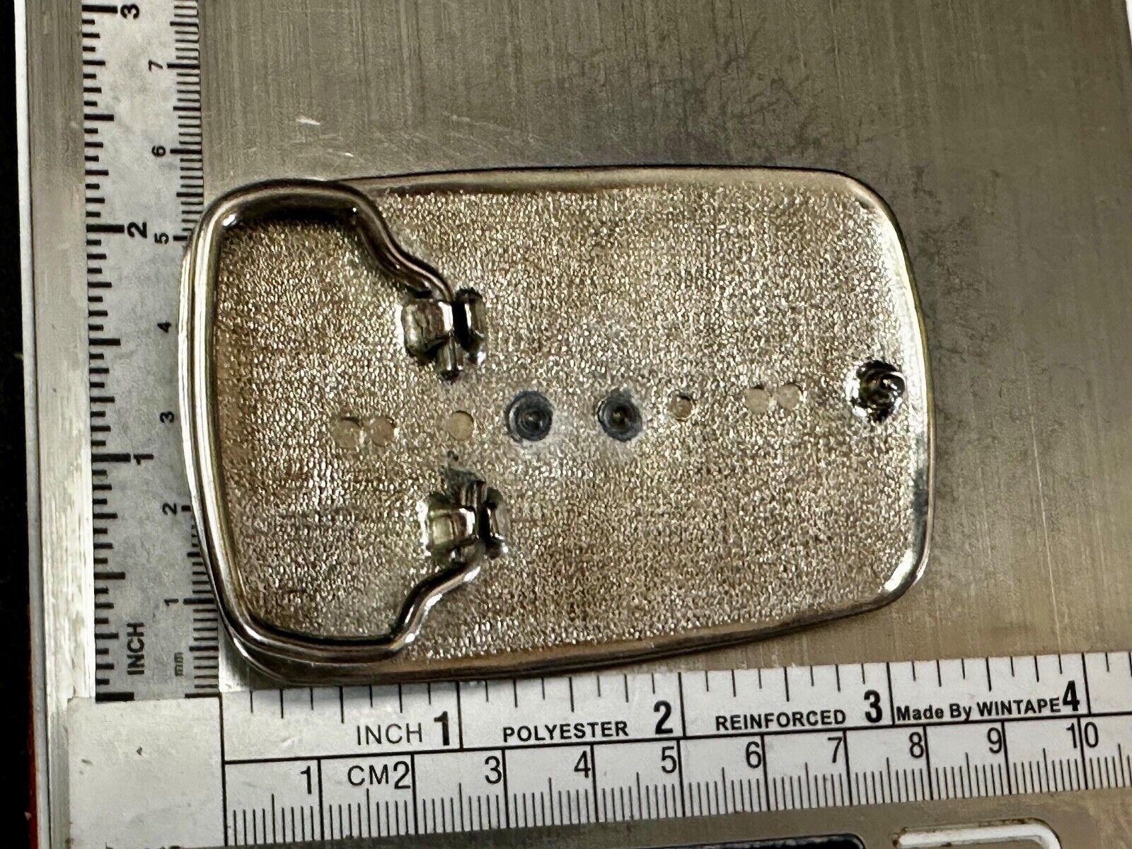 Vintage Cowboy on Saddle Bronc Western belt buckle with mesh pattern background