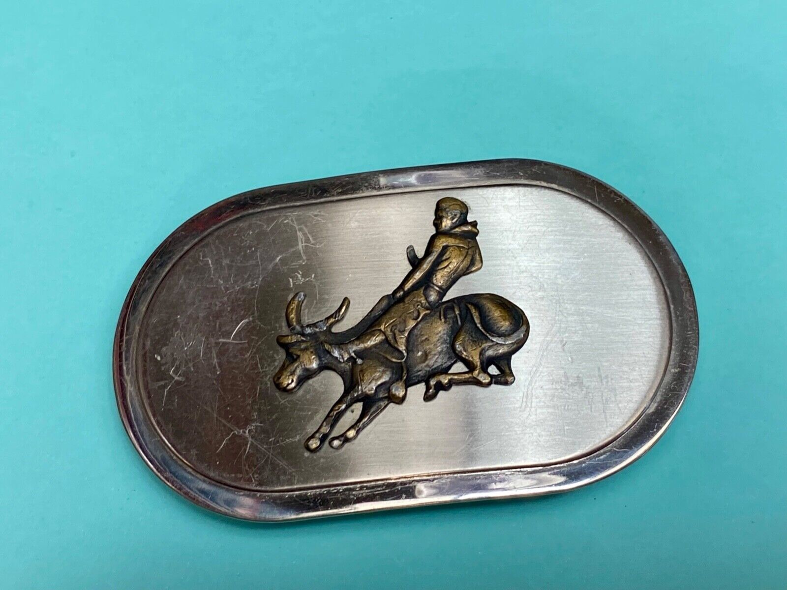 Vintage western oval Rodeo Cowboy on bucking bronc? bull numbered belt buckle