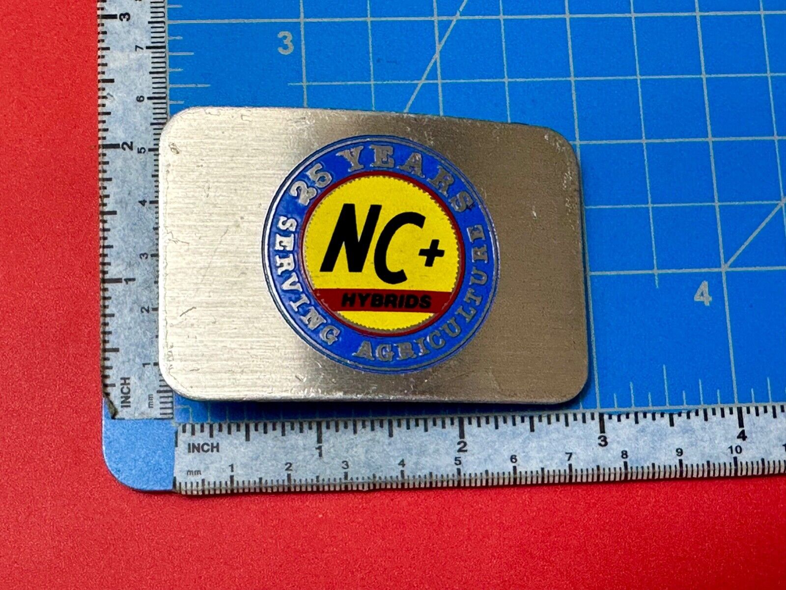 25 years serving agriculture - NC+ Hybrids Farmers Agriculture belt buckle