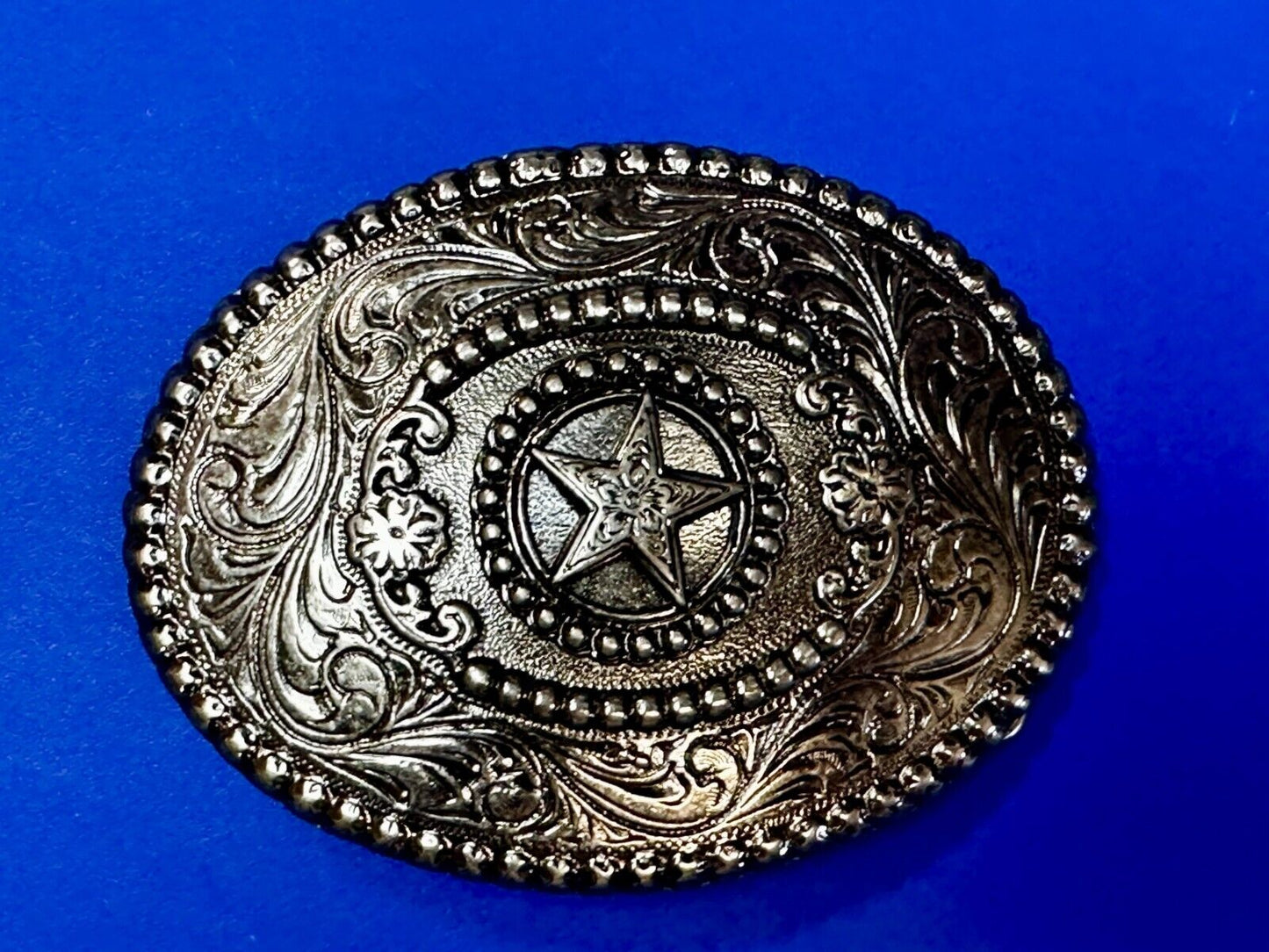 The Lone Star Centered In Oval Flower Swirl Silver Tone Belt Buckle