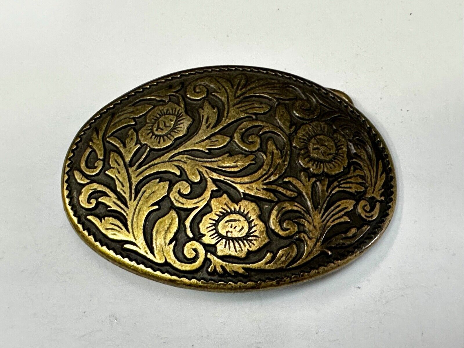 Vintage black and gold tone western flower floral theme cowboys belt buckle