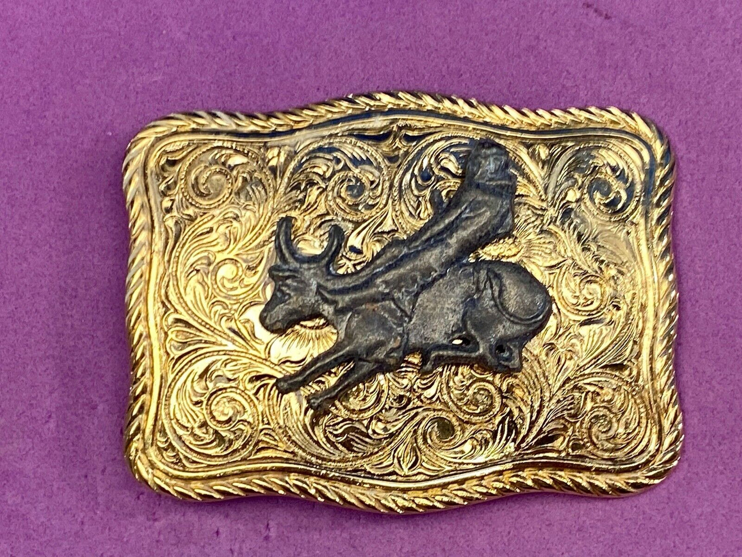 bull riding rodeo cowboy on beautiful gold color flower swirl belt buckle 