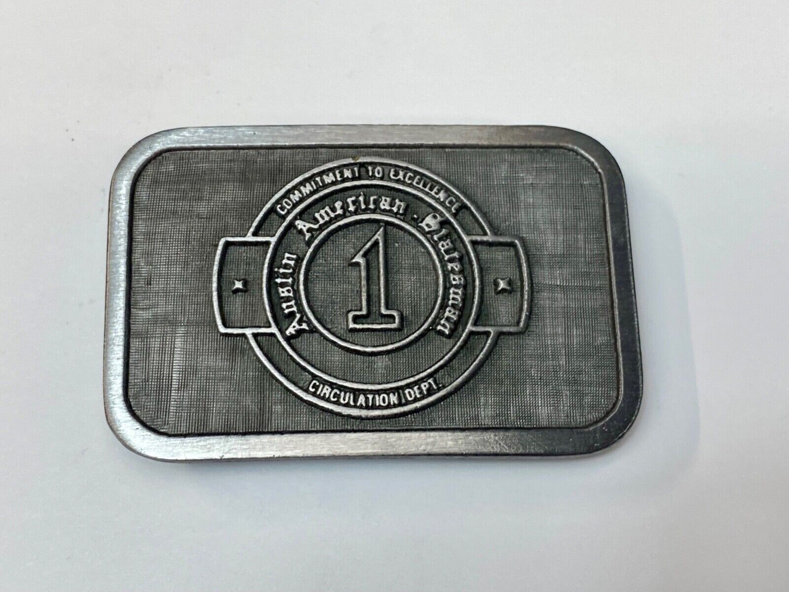 Asian  American  Circulation Dept Commitment to excellence belt buckle hit-line