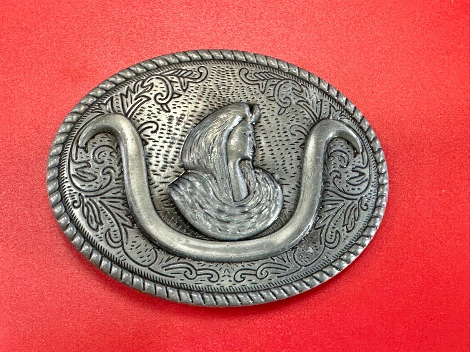 unknown to me!   Man with long hair - longhorn wester belt buckle