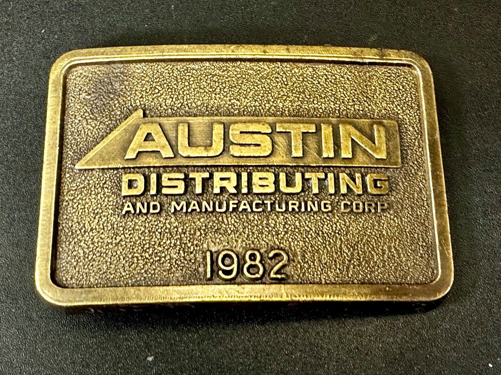 Austin Texas Distributing and Manufacturing 1982 Advertisement Promo Belt Buckle