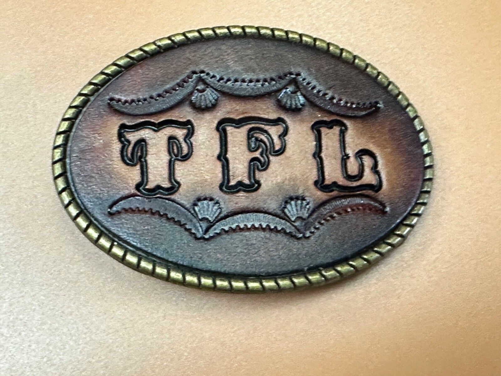 TFL.  vintage western initials letters on leather belt buckle