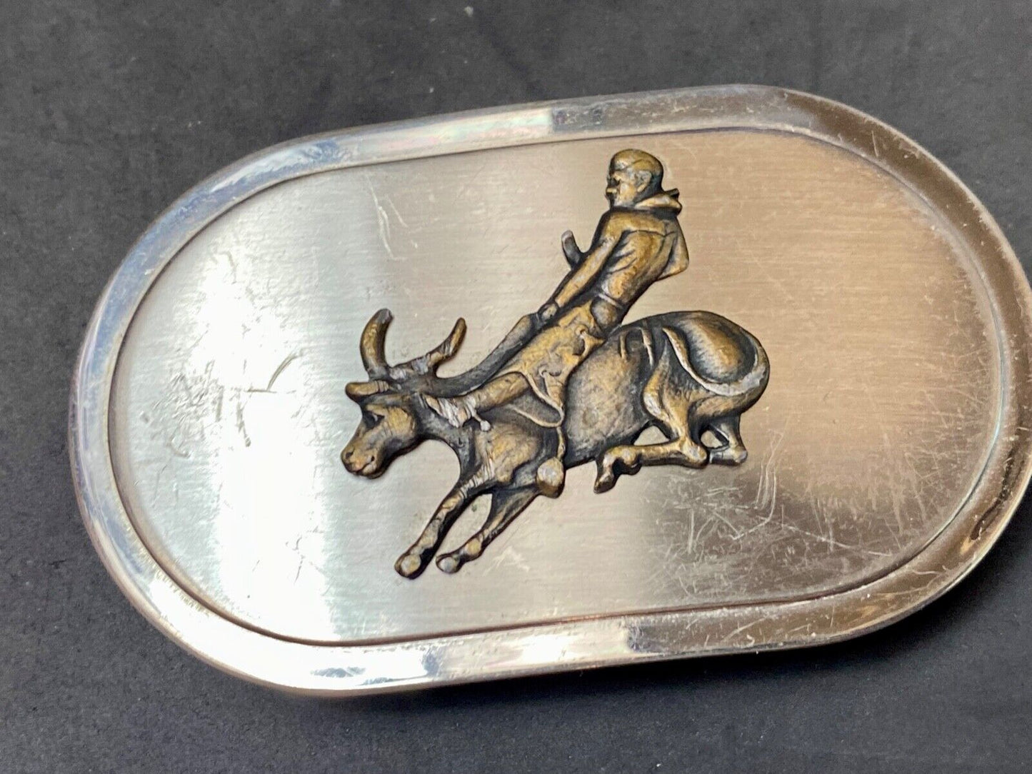Vintage western oval Rodeo Cowboy on bucking bronc? bull numbered belt buckle