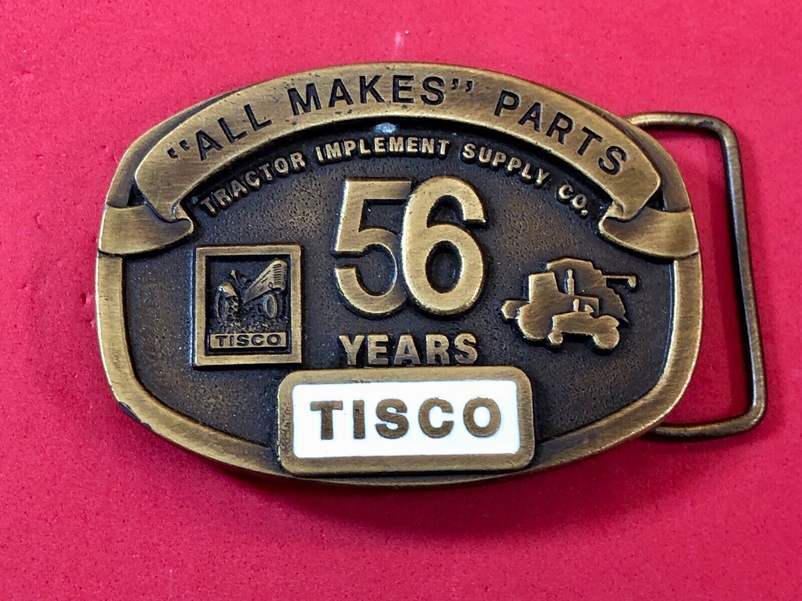 TISCO -   56 years tractor farming parts supply store advertising belt buckle 