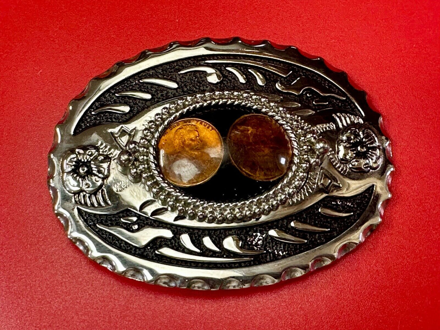 Two lucky pennies coins encased in cab style centerpiece of western belt buckle