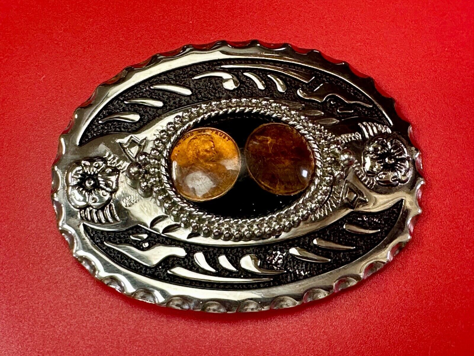 Two lucky pennies coins encased in cab style centerpiece of western belt buckle