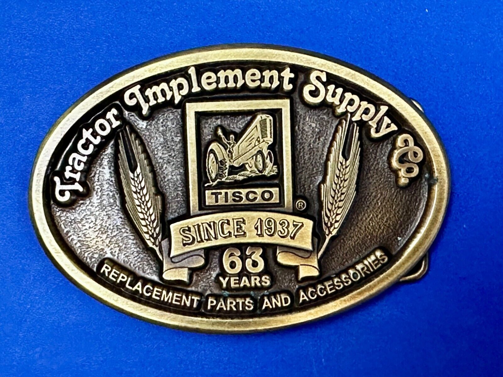 63 years TISCO Tractor Implement Supply company Vintage Belt Buckle by Speccast
