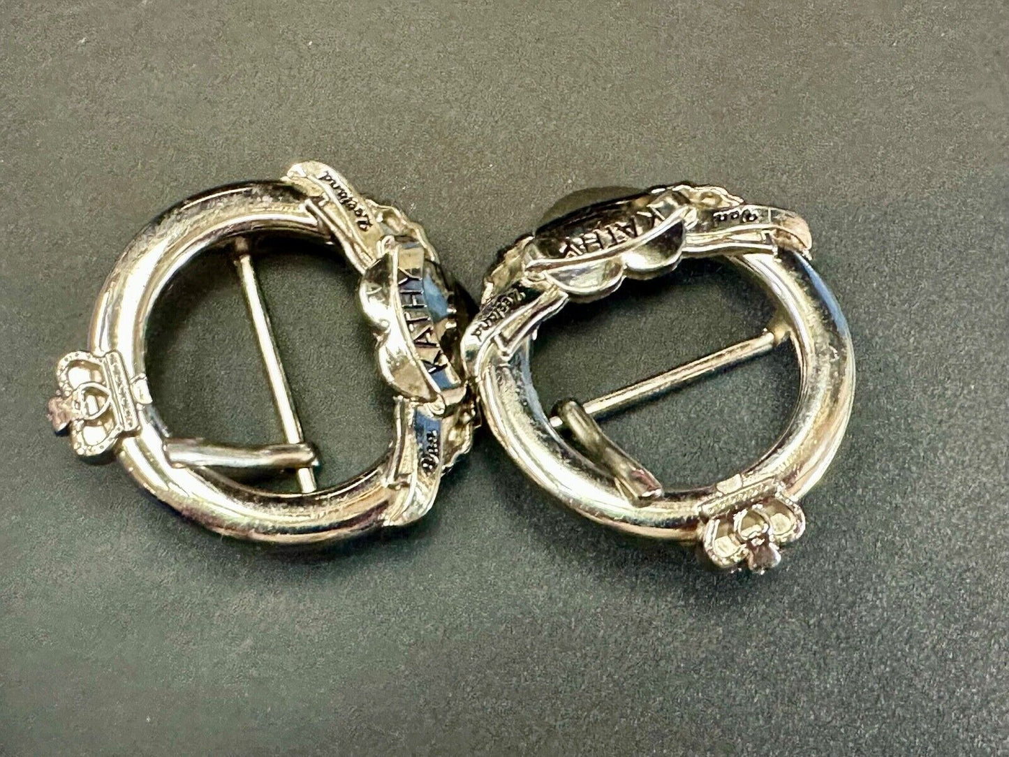 Two Kathy Van Zeeland signed silver tone round heart accented belt buckles