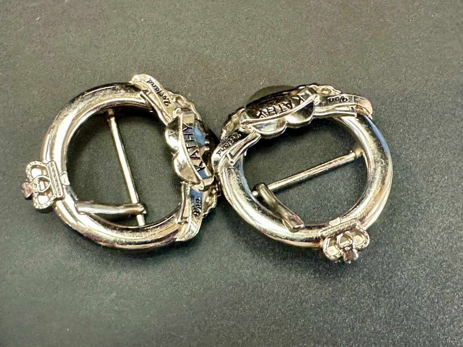 Two Kathy Van Zeeland signed silver tone round heart accented belt buckles