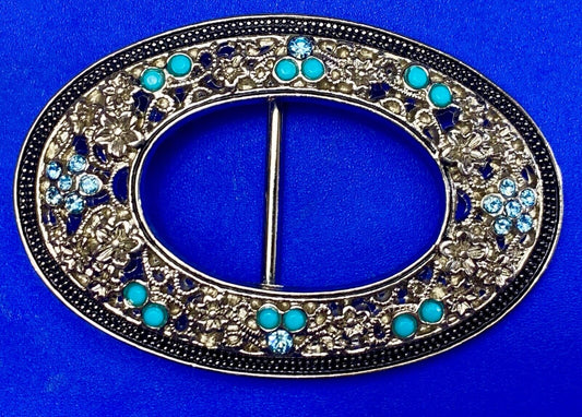 Unique blue rhinestone accented oval see though silver tone belt buckle