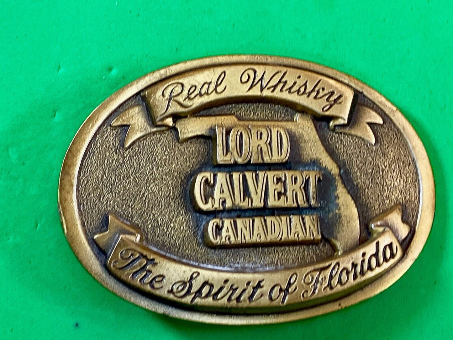 Vintage Lord Calvert Canadian Real Whisky.  Spirit Of Florida Belt Buckle 