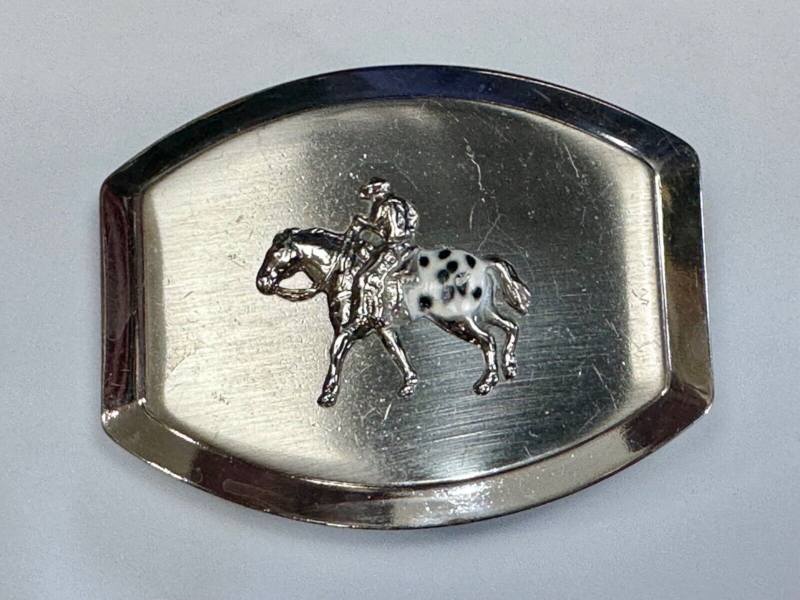 Vintage Horseback Riders cowboys belt buckle with black & white enamel accents